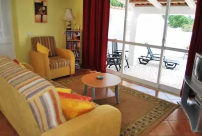 a living room with a couch and a table at Casa Borboleta Gepflegte Villa mit Meerblick, großem Garten und Pool, Traumlage in Aljezur