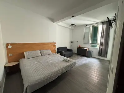 a bedroom with a bed and a chair in it at Cc39-Q2 in Funchal