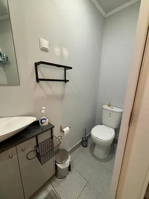 a bathroom with a white toilet and a sink at Cc39-Q2 in Funchal