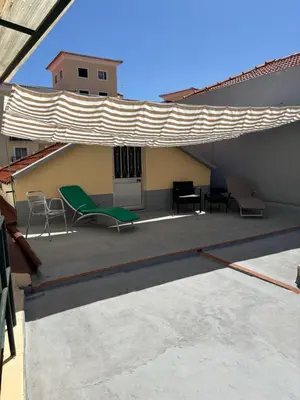 a patio with chairs and awning on a roof at Cc39-Q2 in Funchal