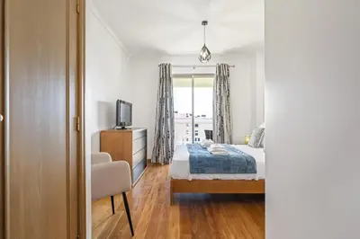 a bedroom with a bed and a tv and a window at Serenity Solace by Homie in Funchal