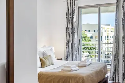 a bedroom with a bed with a large window at Serenity Solace by Homie in Funchal