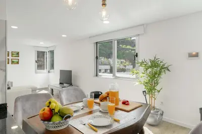 a patio with chairs and a view of the ocean at OurMadeira - TerraceSea Apartments in Ribeira Brava
