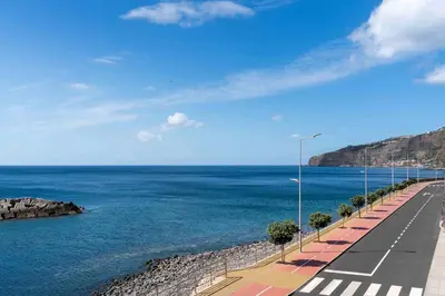 a group of people walking down a dirt trail at OurMadeira - TerraceSea Apartments in Ribeira Brava