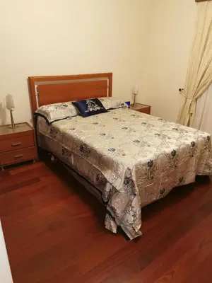 a bedroom with a bed with a comforter on it at The Sun Edge House in Ponta do Sol