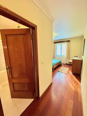 an empty room with a door and a bedroom at The Sun Edge House in Ponta do Sol