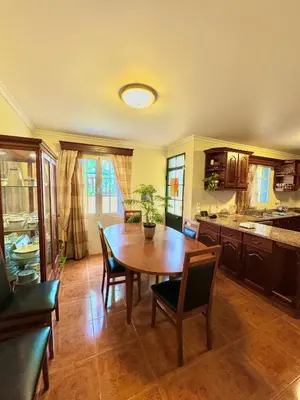 a kitchen with a table and chairs in a room at The Sun Edge House in Ponta do Sol