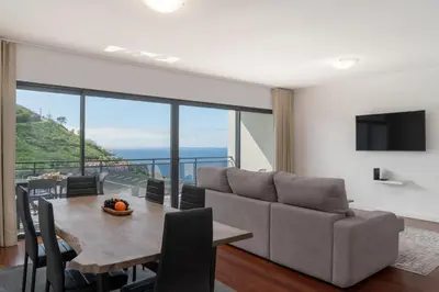 a living room with a table and a couch at Amparo II by An Island Apart in Funchal