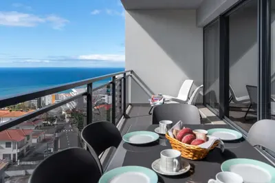 a balcony with a table with a basket of fruit at Amparo II by An Island Apart in Funchal