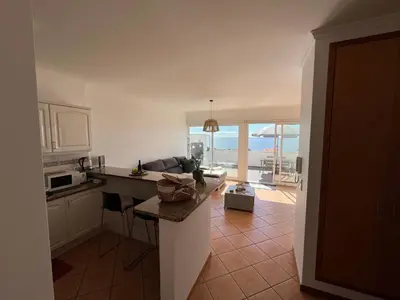 a kitchen with a view of the ocean at Musa Apartment in Madalena do Mar