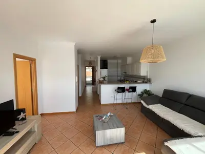 a living room with a couch and a table at Musa Apartment in Madalena do Mar