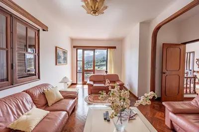 a living room with two pink couches and a table at Silva Retreat Villa in São Jorge