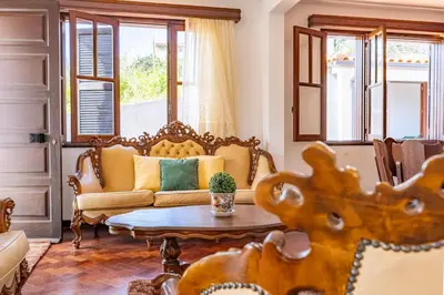 a living room with a couch and a table at Silva Retreat Villa in São Jorge