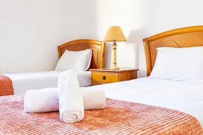 two beds in a room with towels on them at Silva Retreat Villa in São Jorge