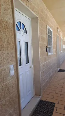 a white door in a bathroom with a walk in shower at Apartamento Amalita em Burgau in Burgau