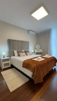 a bedroom with a large bed with a brown blanket at LA VIE Center Flat in Funchal