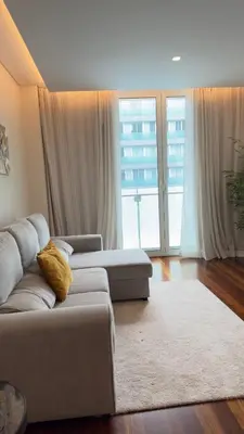 a living room with a couch and a large window at LA VIE Center Flat in Funchal