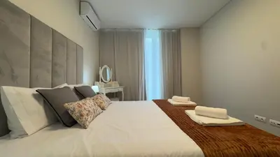 a bedroom with a large bed with two towels on it at LA VIE Center Flat in Funchal