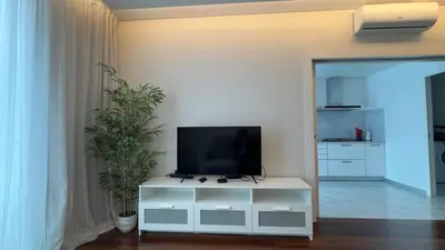 a living room with a tv on a white cabinet at LA VIE Center Flat in Funchal