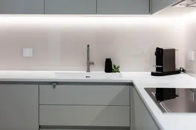 a kitchen with white cabinets and a sink at Savoy Residence Monumentalis N&N by LM&AC Signature in Funchal