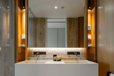 a bathroom with a sink and a large mirror at Savoy Residence Monumentalis N&N by LM&AC Signature in Funchal
