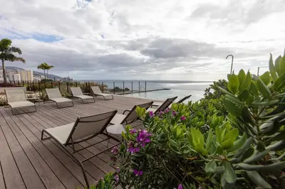 a deck with chairs and a view of the ocean at Savoy Residence Monumentalis N&N by LM&AC Signature in Funchal