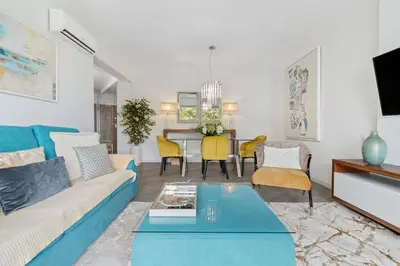 a living room with a couch and a table at Indigo Apartment By The Madeira Luxury Collection in Funchal