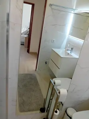 a bathroom with a shower and a toilet and a mirror at apartamento Zarco in Machico