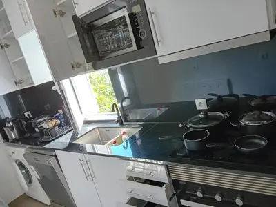 a kitchen with a black counter top and a sink at apartamento Zarco in Machico