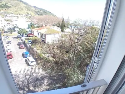 a window with a view of a parking lot at apartamento Zarco in Machico