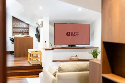 a living room with a tv and a couch at A lovely home in a quiet area in Quinta Grande