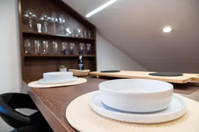 a table with plates and bowls on top of it at A lovely home in a quiet area in Quinta Grande