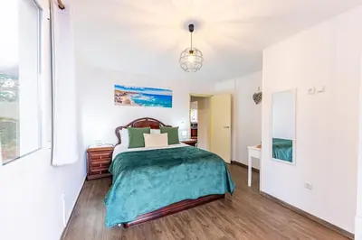 a bedroom with a bed with a green blanket at Recanto do Caminheiro by YOUR KEY in Santana