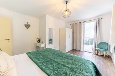 a bedroom with a large bed and a large window at Recanto do Caminheiro by YOUR KEY in Santana