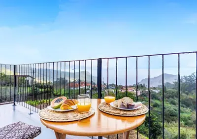a table with two plates of food and glasses of orange juice at Recanto do Caminheiro by YOUR KEY in Santana