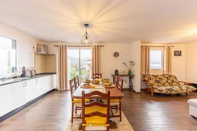 a kitchen and living room with a table and chairs at Recanto do Caminheiro by YOUR KEY in Santana