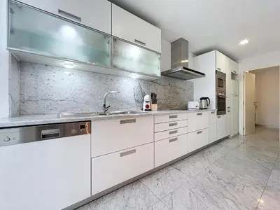 a kitchen with white cabinets and a sink at Acanto Loft by Atlantic Holiday in Funchal