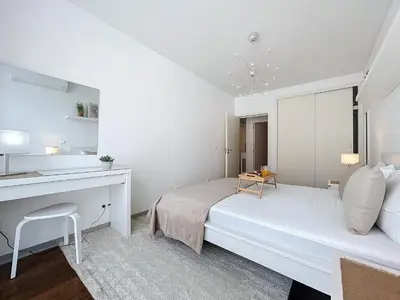 a white bedroom with a bed and a desk at Acanto Loft by Atlantic Holiday in Funchal