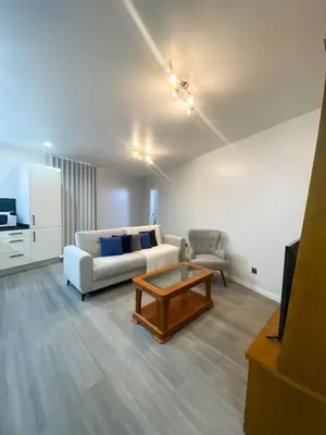 a living room with a couch and a coffee table at Village Square Coastal Apartment 1D in Machico