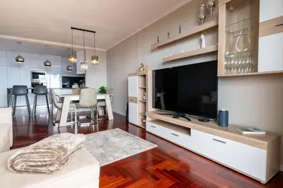 a living room with a large flat screen tv at Garajau Terrace Atlântico in Garajau