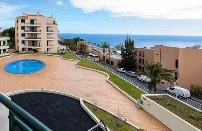 a view from the balcony of a building with a pool at Garajau Terrace Atlântico in Garajau