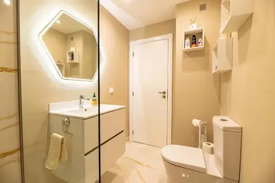 a bathroom with a toilet and a sink and a mirror at Garajau Terrace Atlântico in Garajau