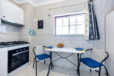 a kitchen with a table and chairs and a window at Luz Heaven - Top floor Seaview Apartment in Luz