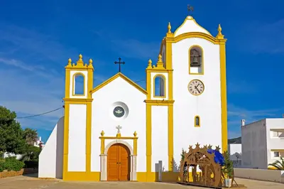 a yellow and white church with a clock tower at Luz Heaven - Top floor Seaview Apartment in Luz