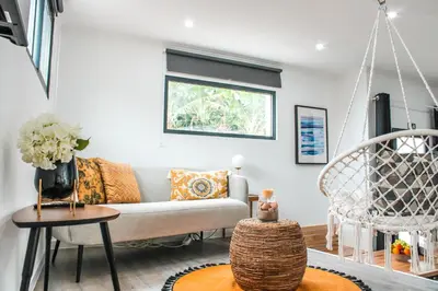 a living room with a blue couch and a table at Casa da Vila Apartments in Arco da Calheta