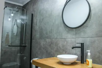 a kitchen with a white table and white chairs at Casa da Vila Apartments in Arco da Calheta
