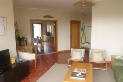 a living room with a green couch and a table at Heritage Villa Porto Santo in Porto Santo