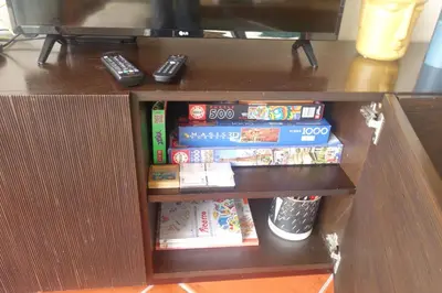 a glass table with books and a vase on it at Heritage Villa Porto Santo in Porto Santo