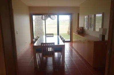a dining room with a glass table and a dresser at Heritage Villa Porto Santo in Porto Santo