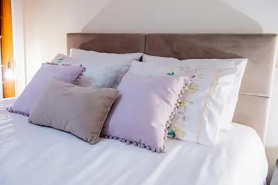 a pile of pillows sitting on a bed at Bugio Guesthouse in Santa Cruz